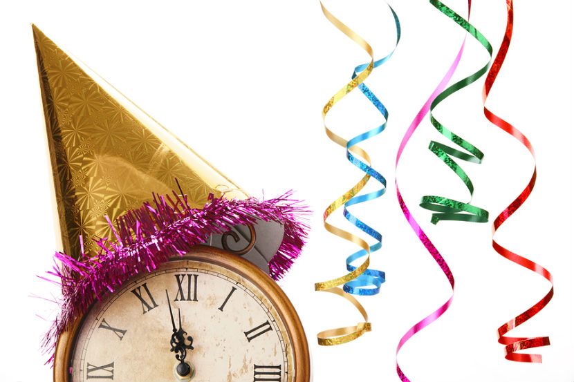 clock with party hat on it and streamers