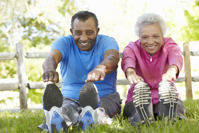 Older couple stretching outside