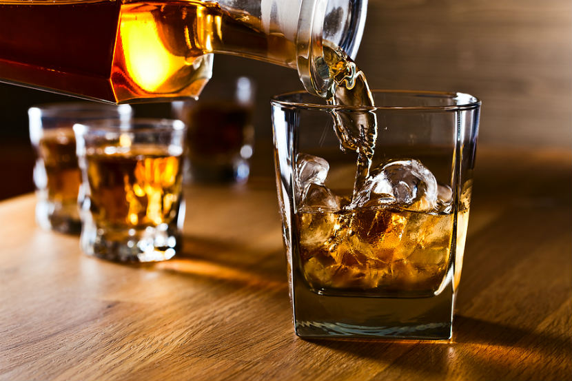 whisky being poured into tumbler