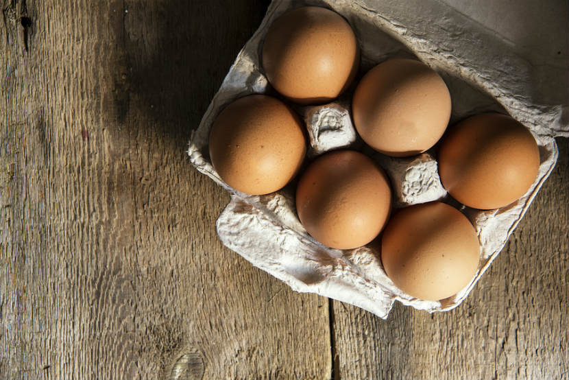 carton of brown eggs on a table
