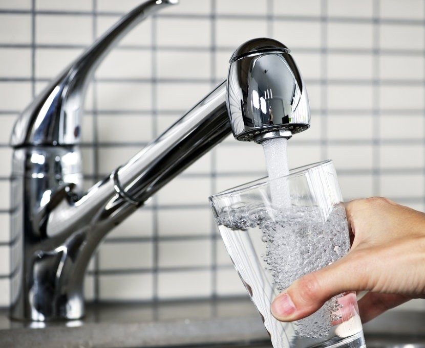 kitchen tap pouring water into glass