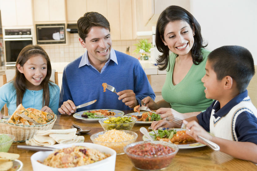 family at a dinner table eating together