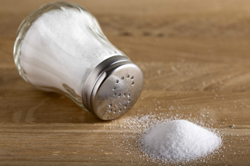 a salt shaker on a table tipped over