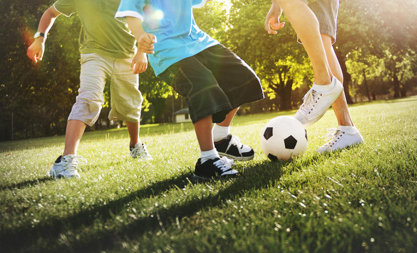 3 boys playing soccer