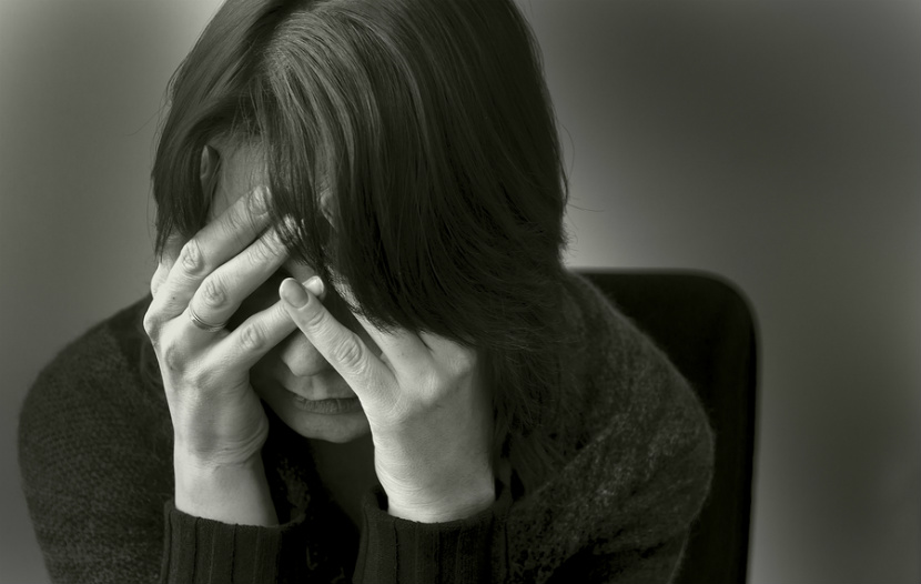 woman holding head in despair