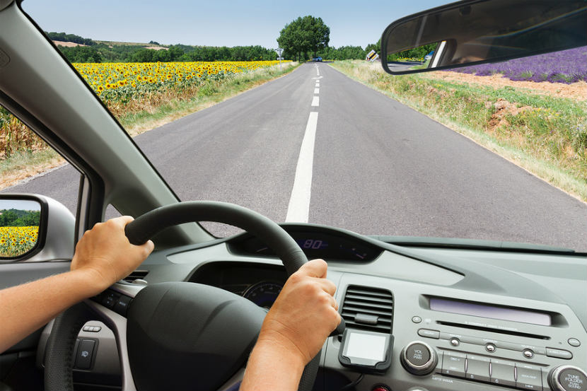 person driving in a car on a road