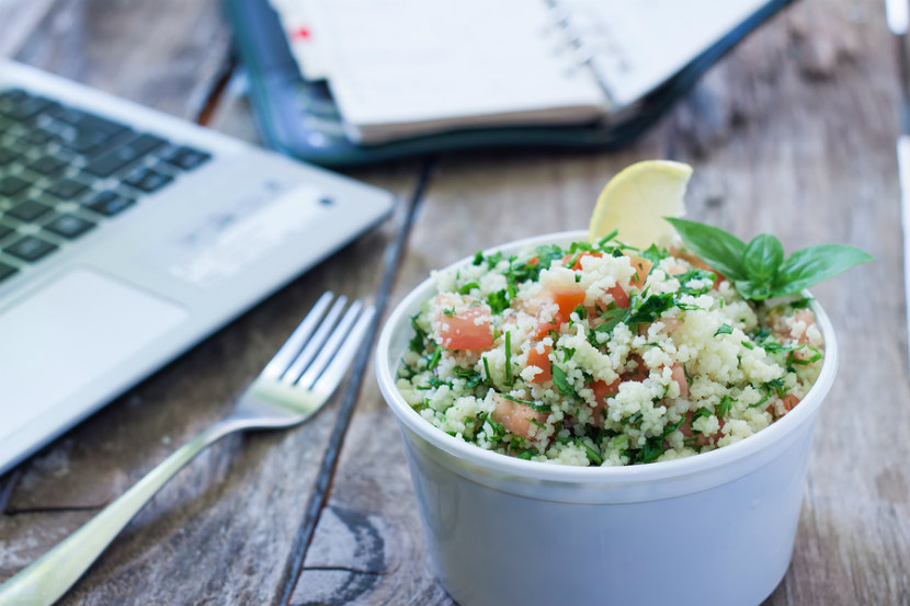 vegetable and couscous lunch salad on desk at work