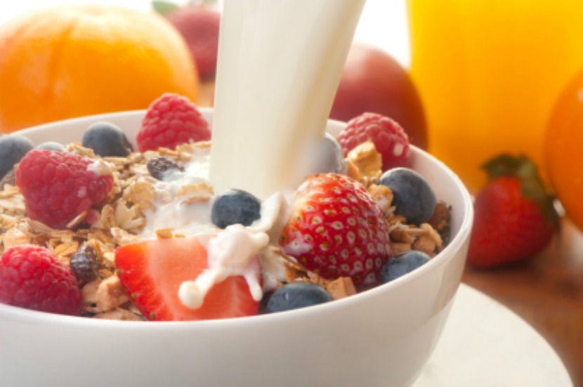 bowl of cereal with fruit on top; a balanced breakfast