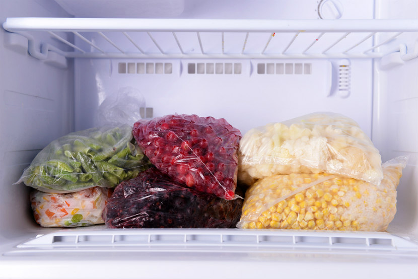bags of frozen foods in freezer