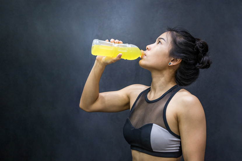 woman drinking a sports drink