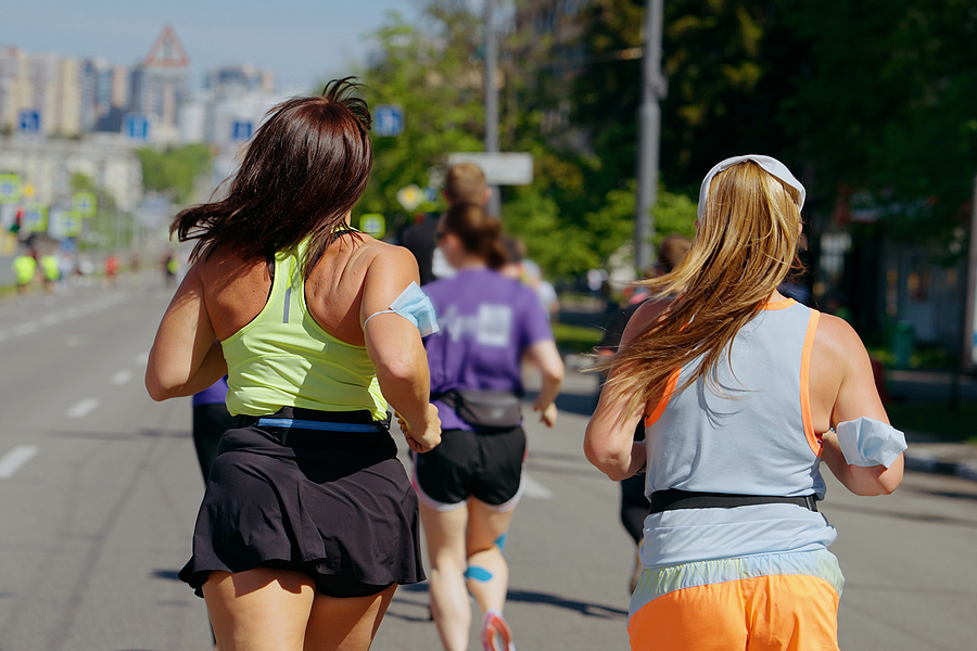 two people running a race in the city