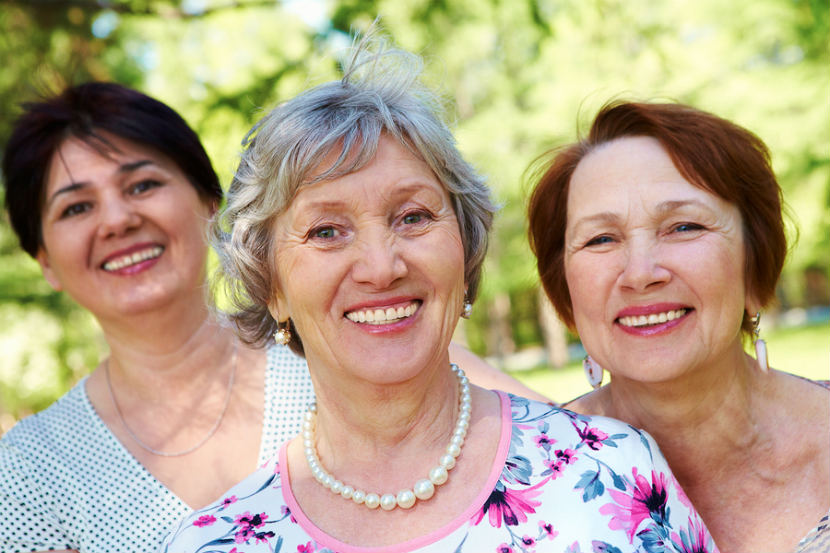 three smiling older women