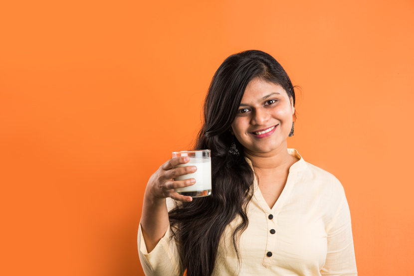 woman drinking a glass of milk