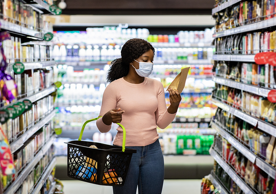 woman shopping in produce section of grocery store