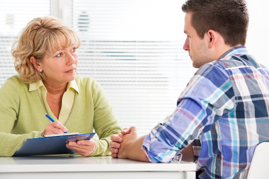 man sitting down in a counselling session with a female dietitian