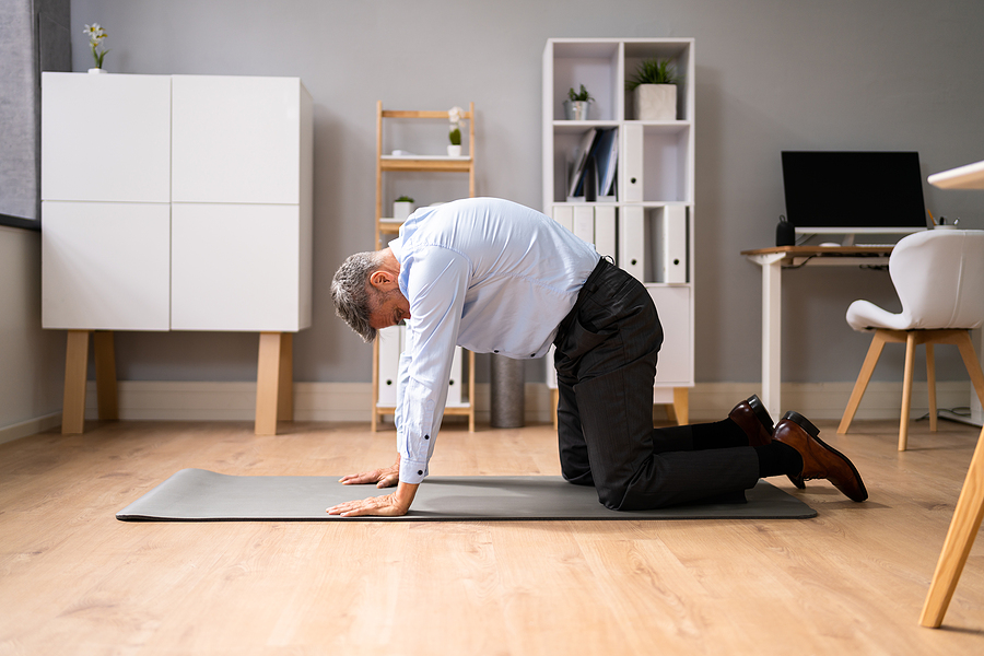 person exercising and stretching at work