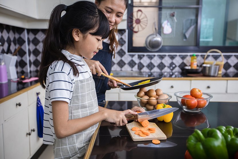 Dish washing concept. Child boy washing the dishes in the kitchen