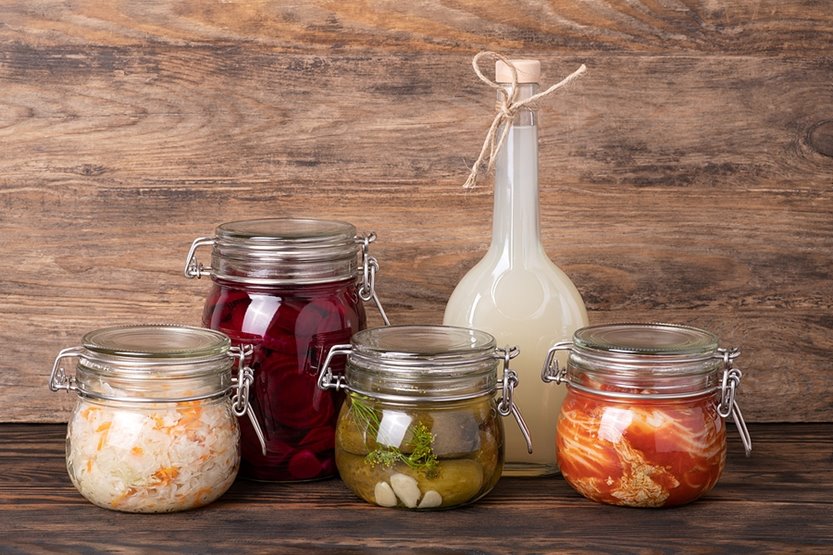 : jars of fermented and pickled foods like pickles, kimchi and beets.